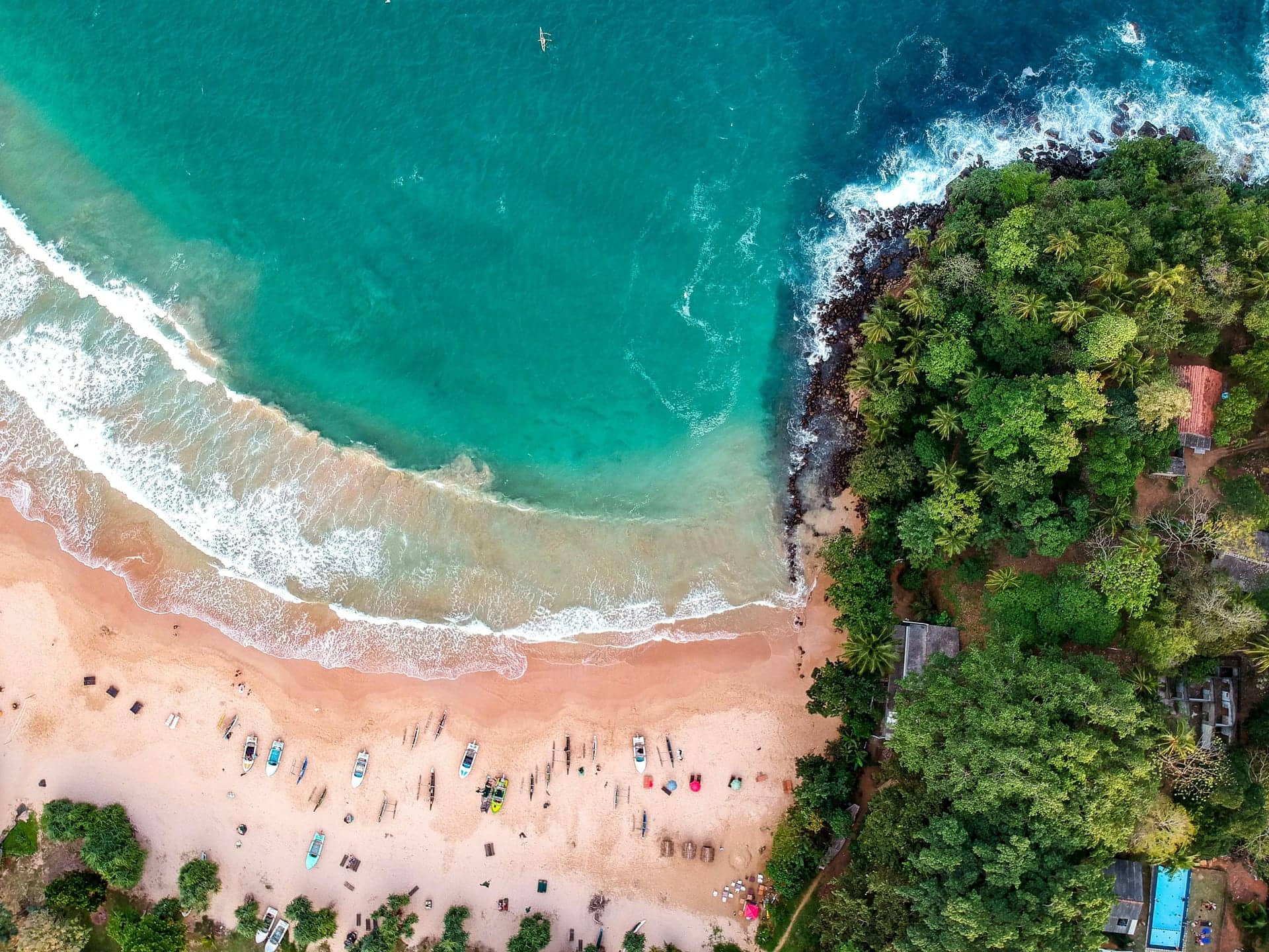 Aerial view of a golden beach and turquoise bay on Sri Lanka's south coast